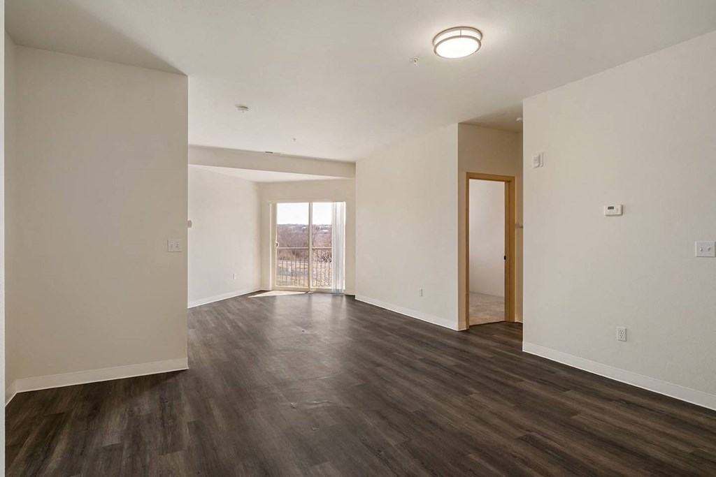 Living room with wood flooring, white walls and overhead lighting.at Shoreline Village, Richland, 99352