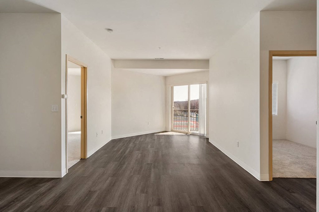 Open living room with hardwood flooring, white walls and filled with natural light.at Shoreline Village, Richland, WA