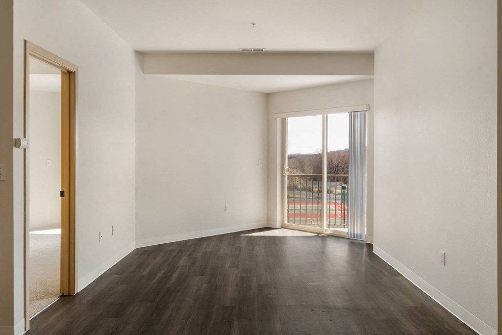 a spacious living room with white walls and sliding glass doors to the private balcony.at Shoreline Village, Richland, WA 99352
