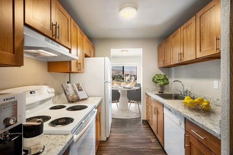 a kitchen with white appliances and wooden cabinets