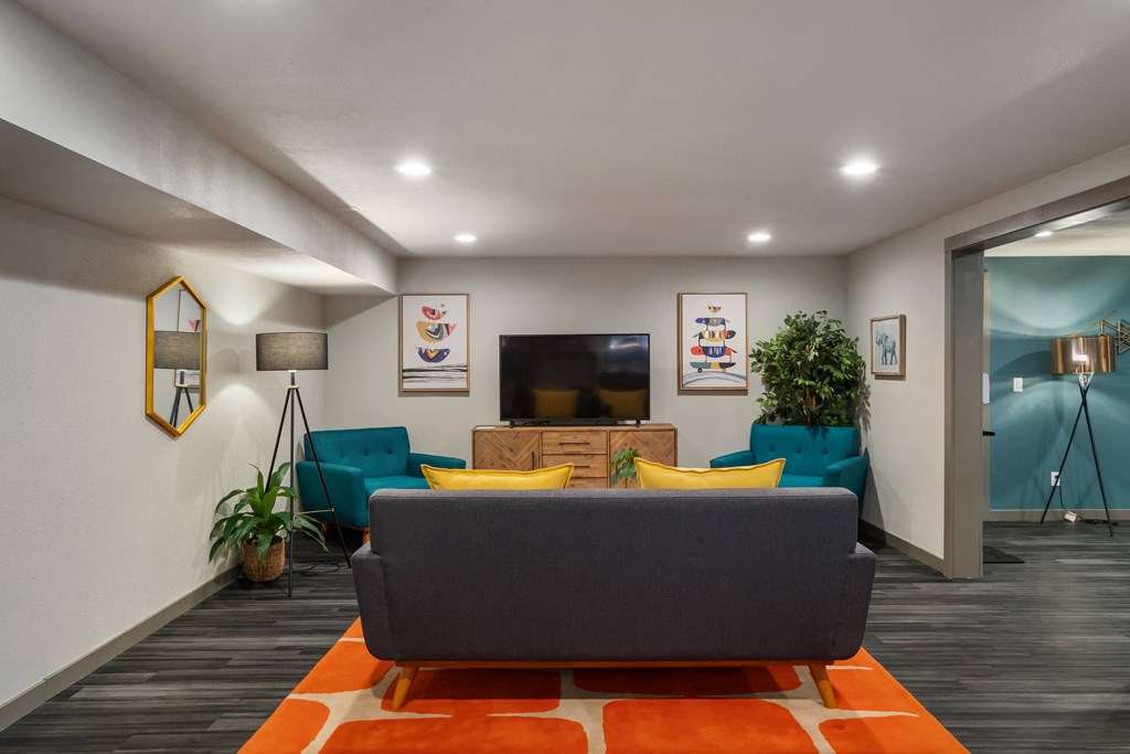 a living room with blue couches and yellow and orange pillows at Cedarwood, Wenatchee