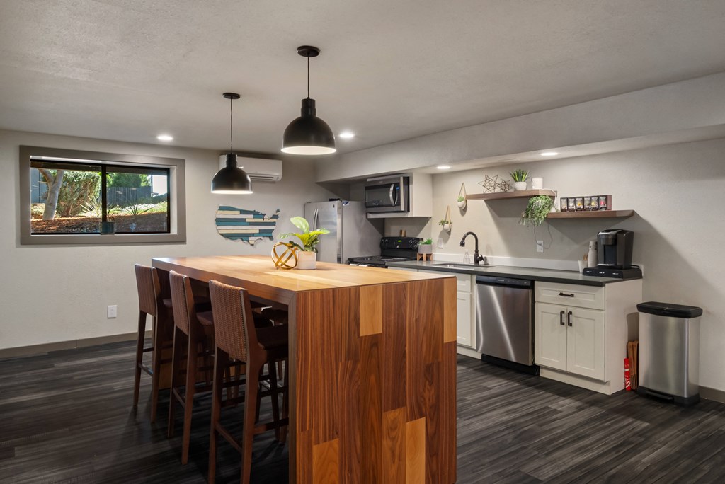 a kitchen with white cabinets and a wooden island with a wooden countertopat Cedarwood, Wenatchee, WA