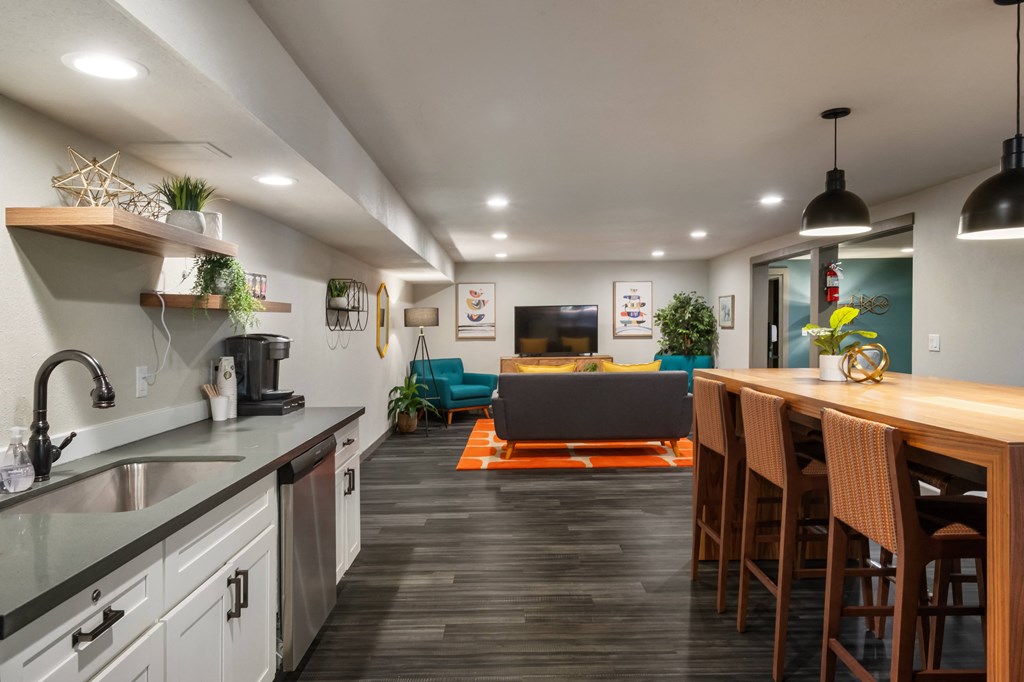 a kitchen with white cabinets and a wooden counter top next to a living room with a couch at Cedarwood, Wenatchee, WA 98801