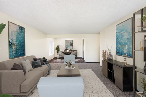a living room with a couch coffee table and a dining room table in the background at Castlerock, Wenatchee Washington