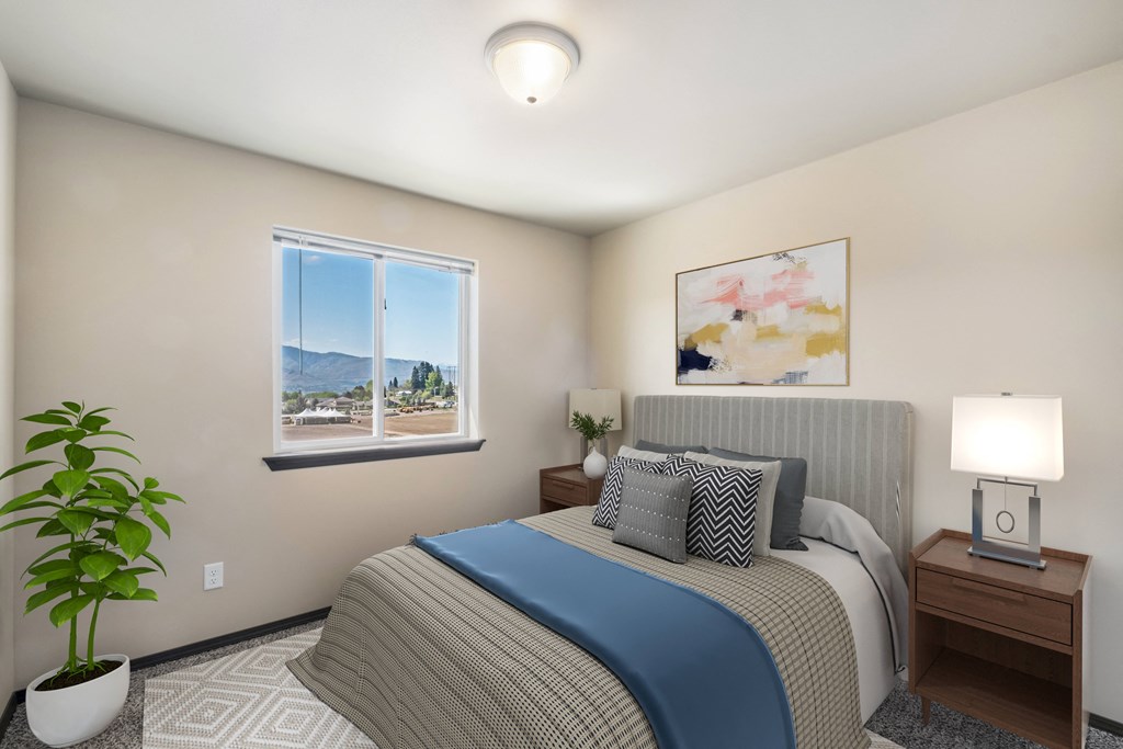a bedroom with a large bed and two night stands with lamps  at Altitude, East Wenatchee, WA, 98802