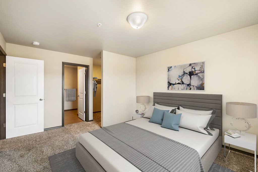 a bedroom with a large bed and a door to a bathroom  at Altitude, East Wenatchee, Washington