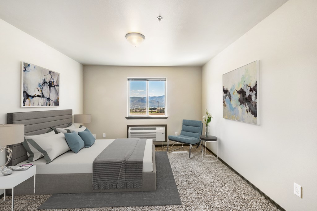 a bedroom with a bed and a chair in a 555 waverly unit a bedroom with a bed and a chair in a 555 waverly unit at Altitude, East Wenatchee