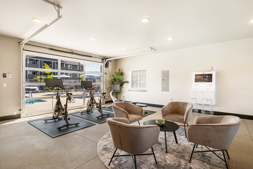 a resident fitness center with exercise machines and chairs  at Altitude, East Wenatchee, 98802