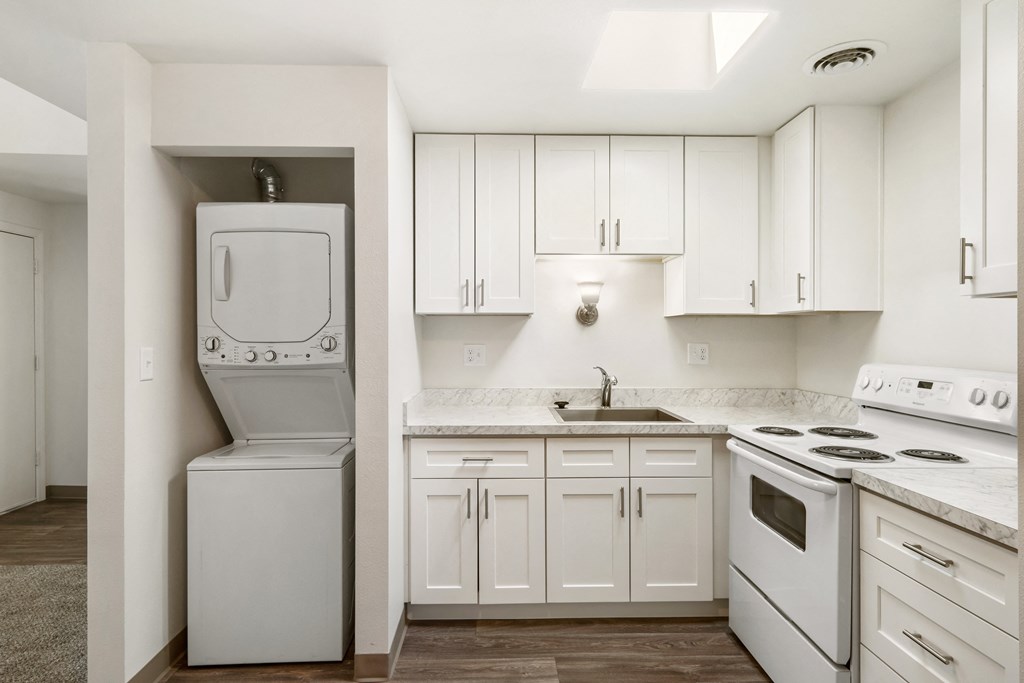 a white kitchen with white appliances and white cabinets at Park View Apartments, Wenatchee, WA