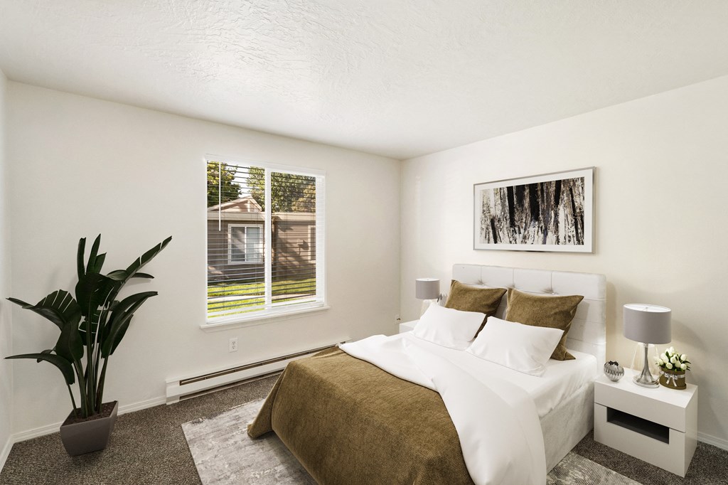 a bedroom with a large bed and a plant in a corner of the room at Park View Apartments, Washington