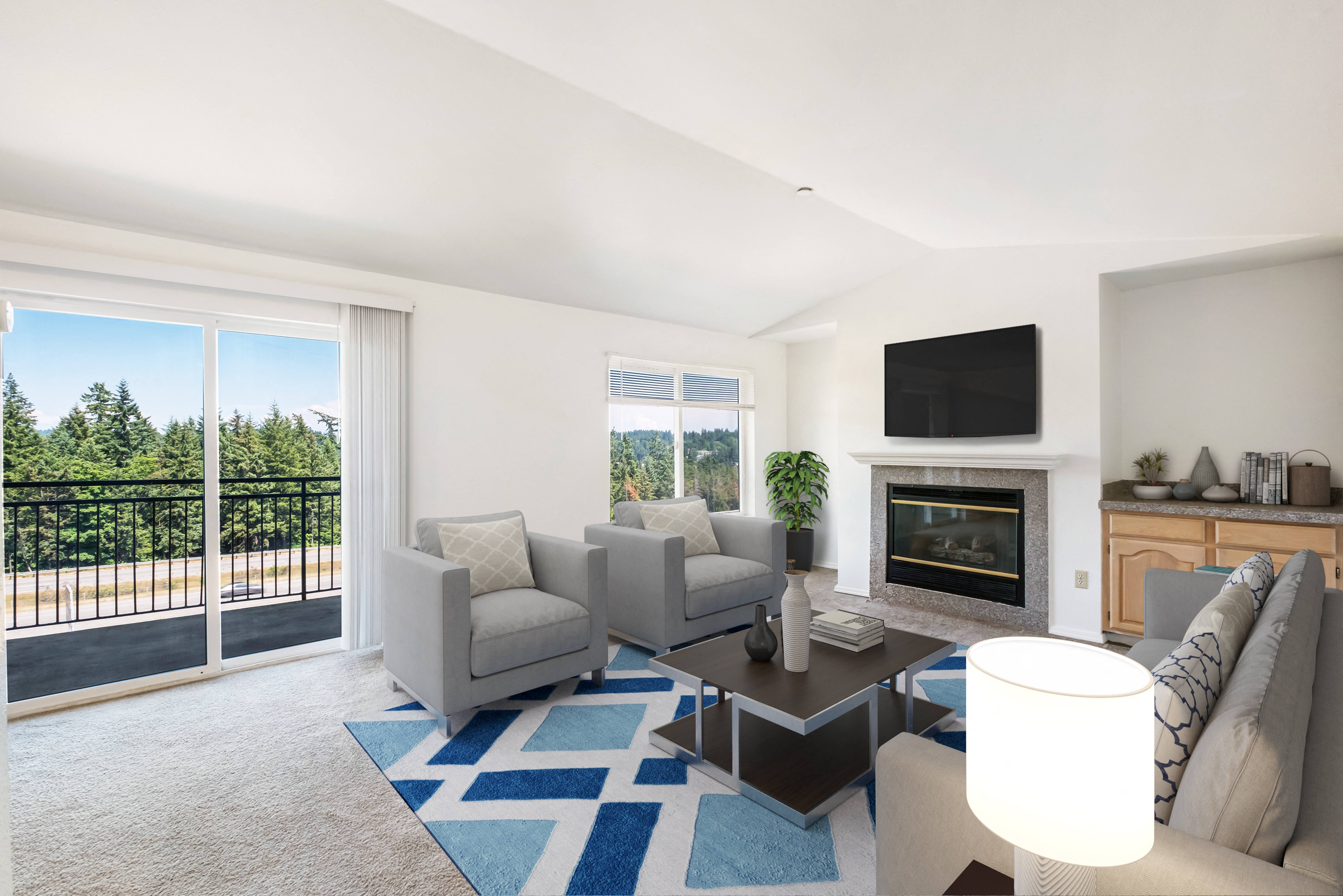 a living room with couches and a coffee table in front of a fireplace