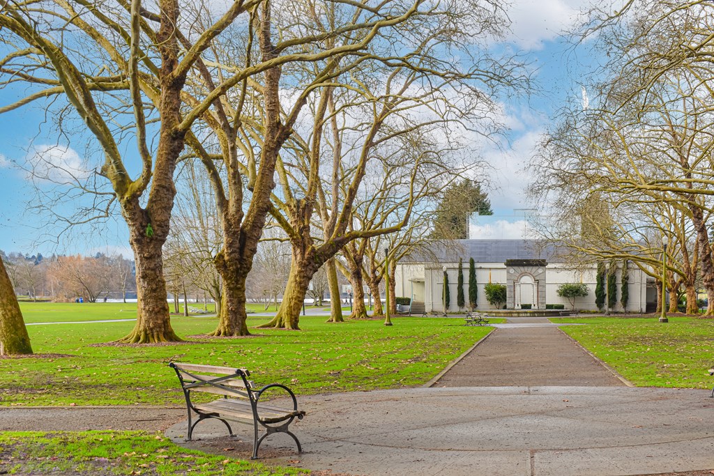 a park bench in front of a building with trees
