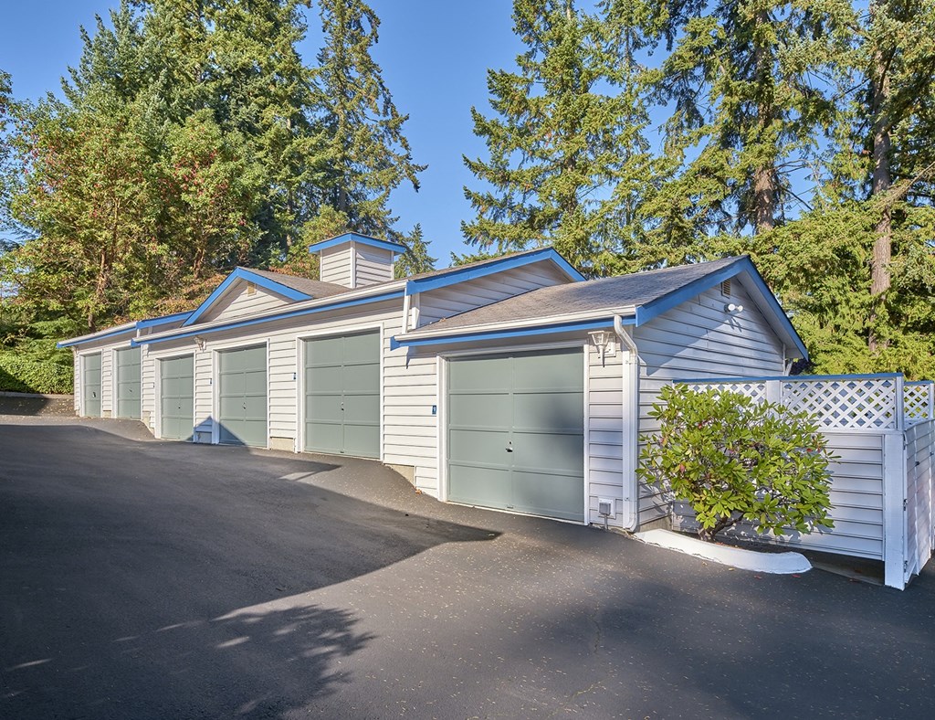 a row of garages with green doors on the side of a street at Edmonds Gateway, Edmonds, 98026