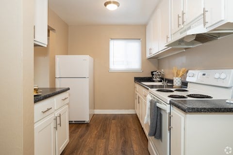 a kitchen with white appliances and white cabinets at Ella 1711 Apartments, Woodland, 95695