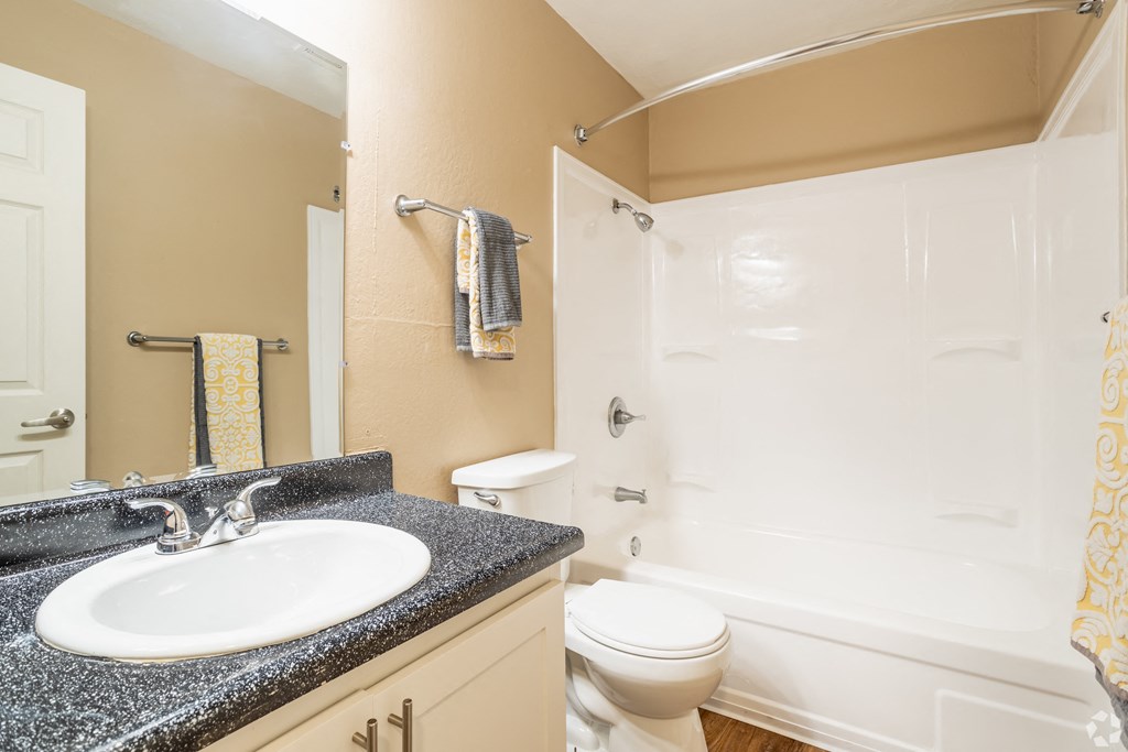 a bathroom with a sink toilet and full bathtub at Ella 1711 Apartments, Woodland California