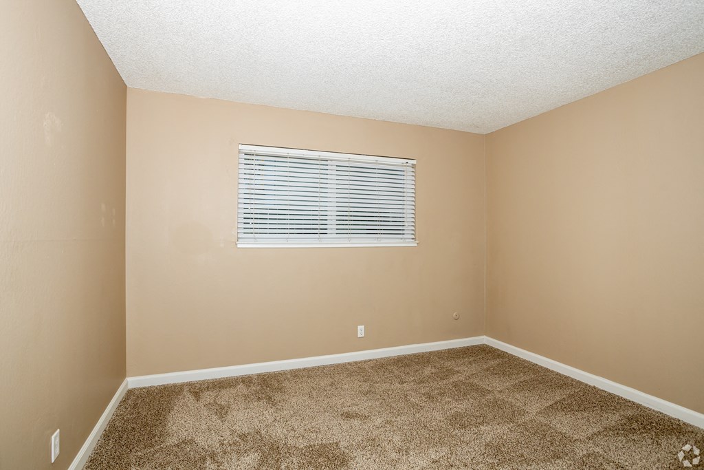 an empty room with carpet and a window  at Ella 1711, Woodland, California