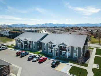 an aerial view of a building with cars parked in a parking lot at Madison Park, Bozeman