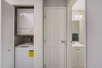 a white kitchen with a white door and a white refrigerator and sink at Capitol Crossing, Olympia, WA