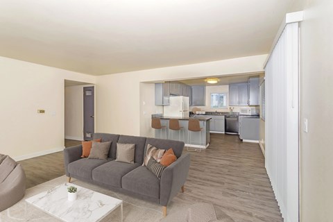A living room with a grey couch and a coffee table.