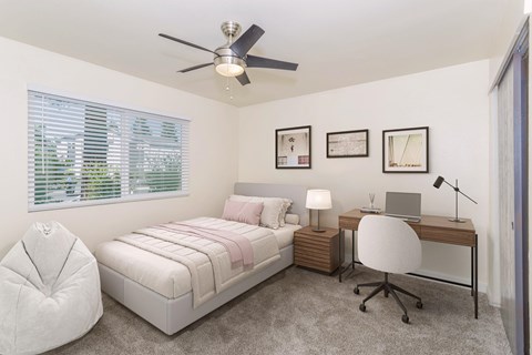 Cozy bedroom with bed and study area in Gateway Apartments student housing Chico, CA
