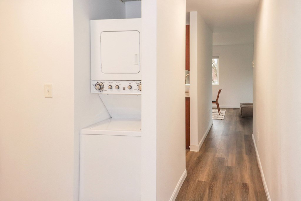 A long hallway with a washer and dryer to the left at our apartments for rent in Renton, WA