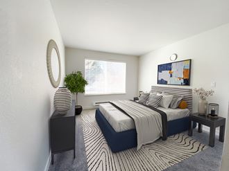 An apartment bedroom with white walls, a large window on the back wall and gray carpet. Staged with a queen-size bed, side tables, a dresser and a rug.  - Photo Gallery 3