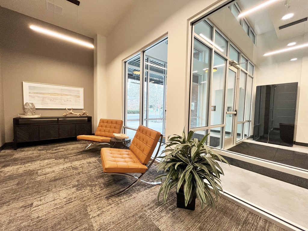a room with two chairs and a table in front of a large window at The Duo, University Place, 98466