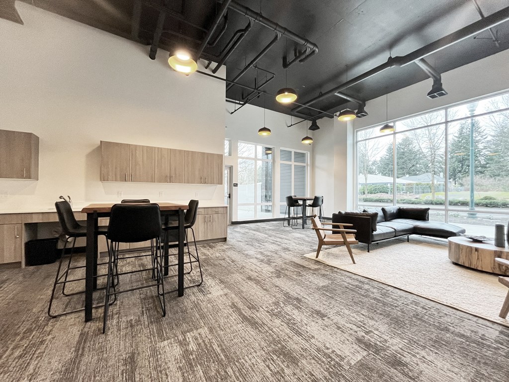 an open living room with a kitchen and dining area with a large window at The Duo, Washington