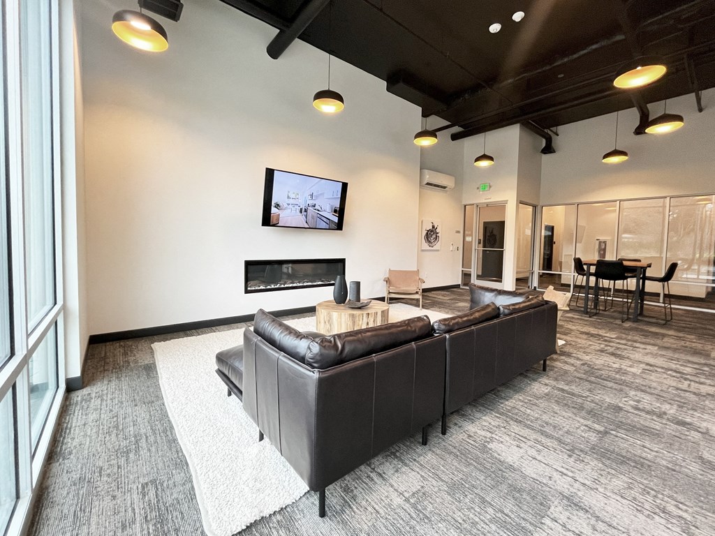 a large living room with a leather couch and a tv at The Duo, University Place, WA 98466 