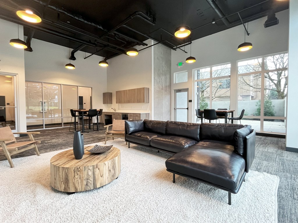 a living room with a leather couch and a coffee table at The Duo, University Place, WA 