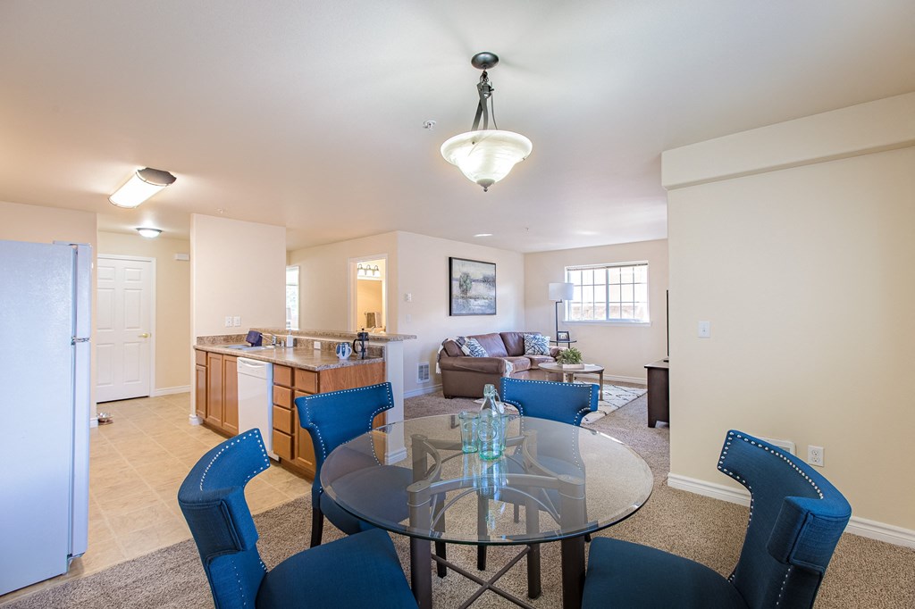 a living room with a glass table  and a kitchen  at Quail Springs, West Richland, Washington