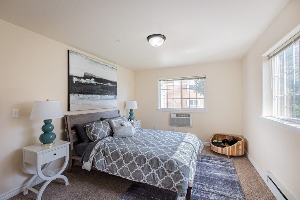 a bedroom with a bed and two windows  at Quail Springs, Washington