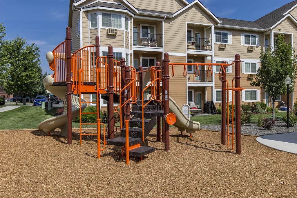 an orange playground in front of an apartment building  at Quail Springs, Washington, 99353