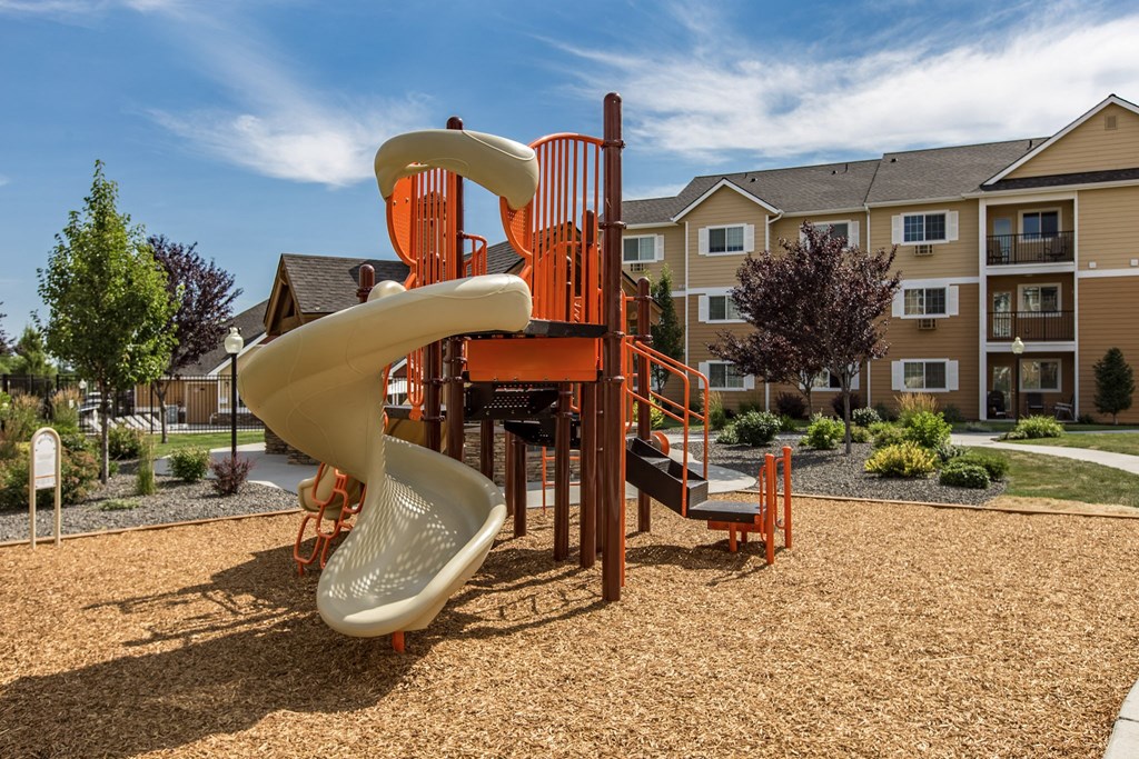 a playground with a slide at Quail Springs Apartments