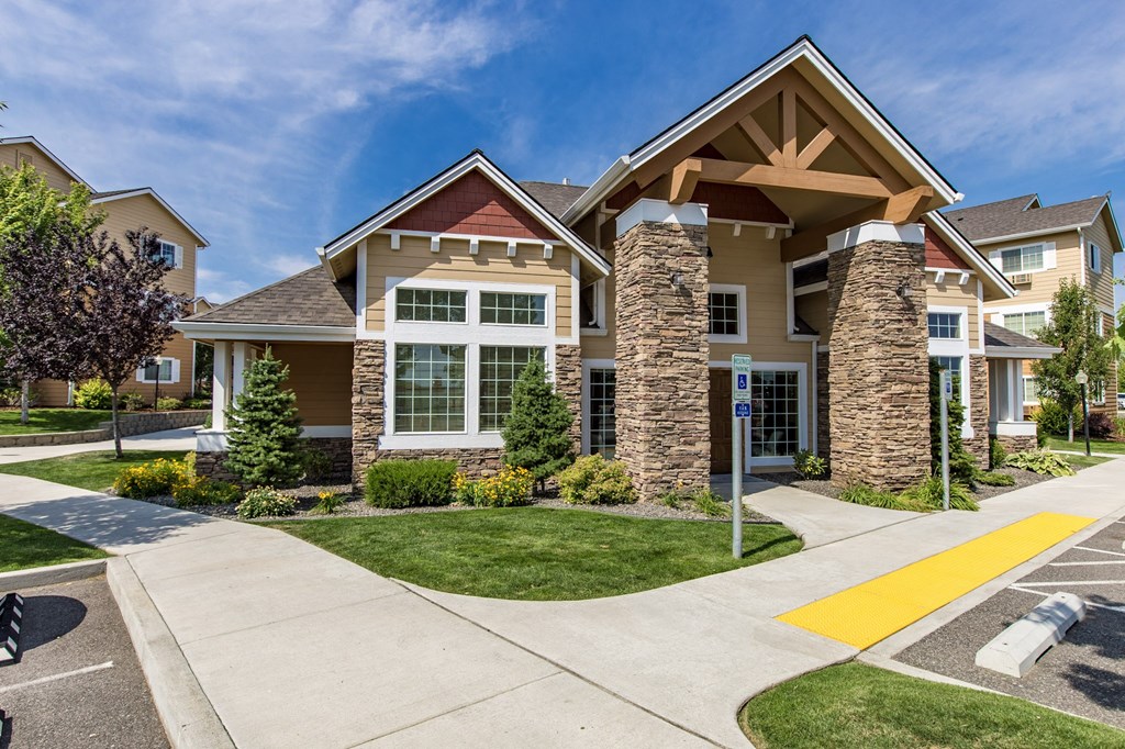entry way with a sidewalk and green grass at Quail Springs Apartments