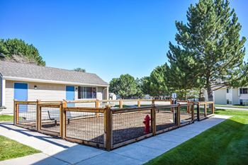 Dog park at Kirkwood Meadows Apartments in Pocatello, ID. Fenced dog park with bench and fire hydrant