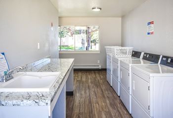 Kirkwood Meadows community laundry room with washer and dryers and tables