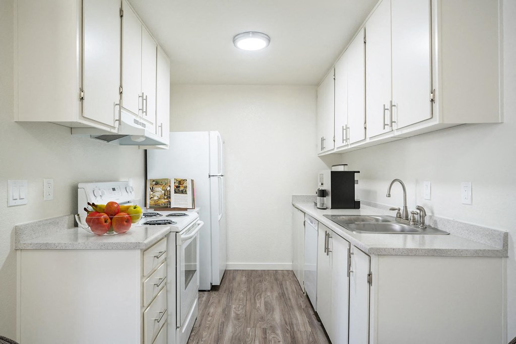 a kitchen with white cabinets and white appliances at Kirkwood Meadows, Pocatello, ID