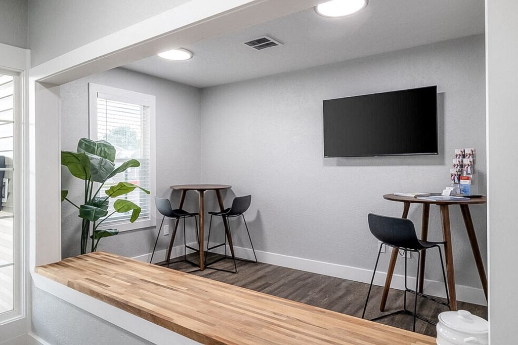 a living room with a table and chairs and a television at Kirkwood Meadows, Pocatello, ID 83201