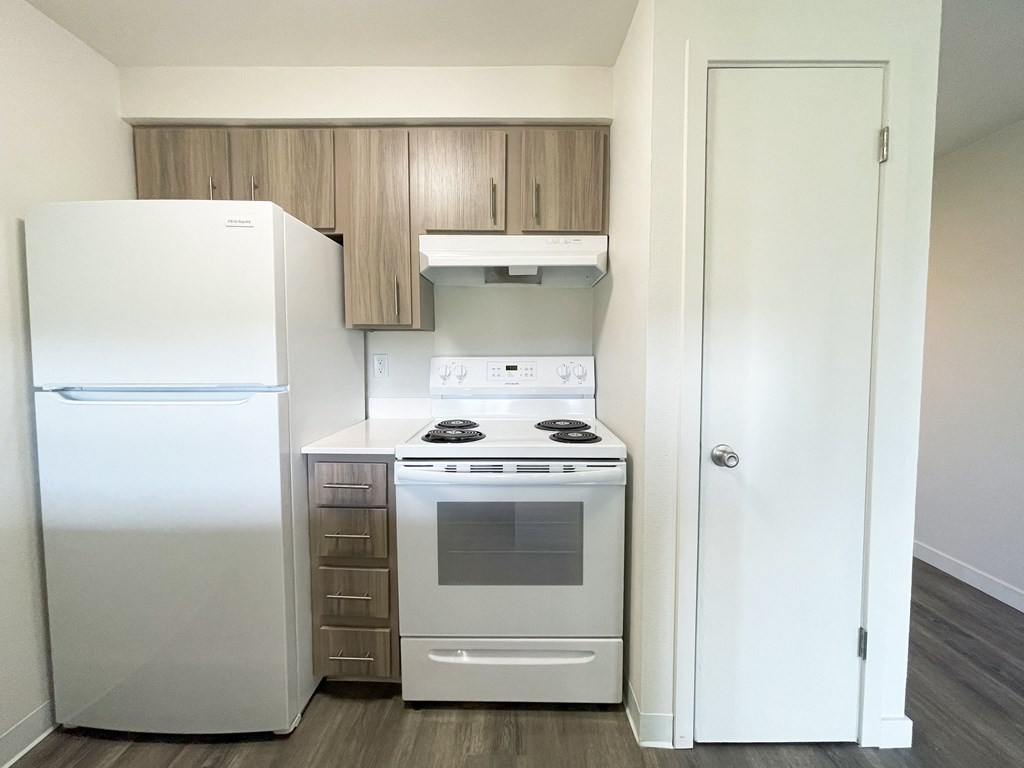 a kitchen with white appliances and a refrigerator and a stove  at The Trail, Snohomish, Washington