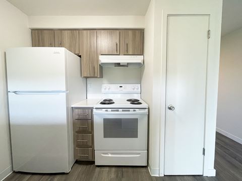a kitchen with white appliances and a refrigerator and a stove