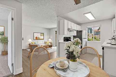 A dining room with a table set for two.