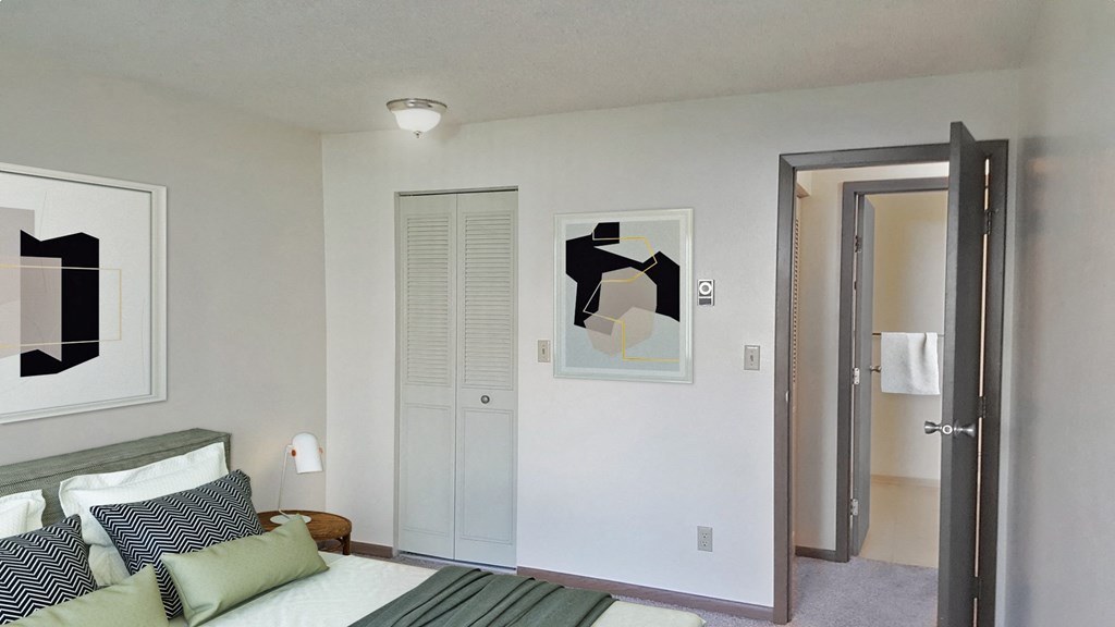 Bedroom corner with bed, closet, and door leading to the hallway and bathroom from left to right.at Laurel Park, Twin Falls, Idaho