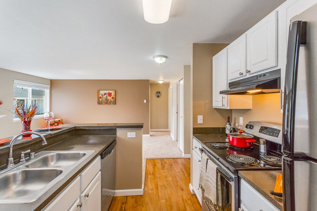a kitchen with a stove and a sink and a refrigerator at Springfield, Washington, 98055 