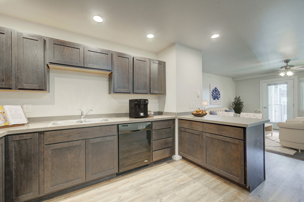 a kitchen with wooden cabinets and a counter top and a sink at Madison Park, Bozeman