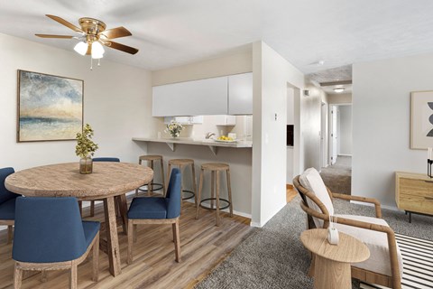 A modern dining room with a round table and blue chairs at apartments in Post Falls, ID.