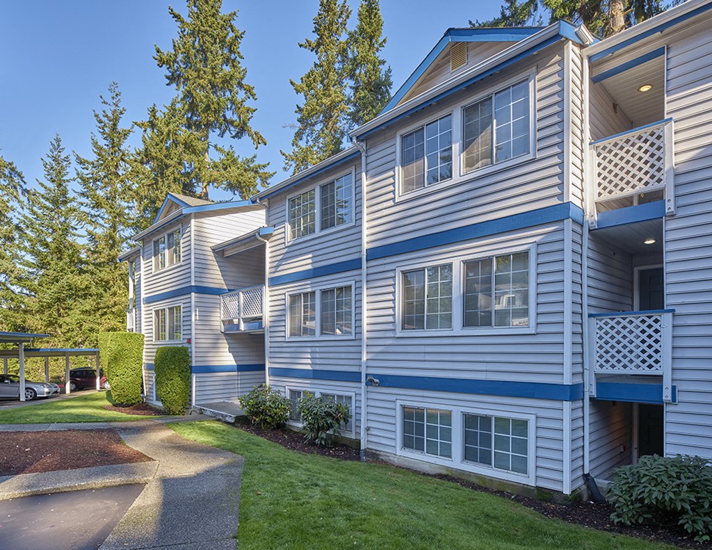 Outside Edmonds Gateway Exterior view of building with trees, manicured lawn and paved path.at Edmonds Gateway, Washington, 98026