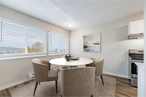 Dining area at Peak 88 Apartments in Renton, WA with table seating and open layout