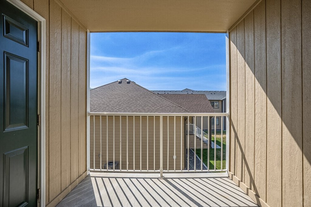 a balcony with a view of a house