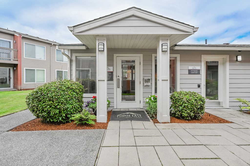 A small building with a porch and a sign that says